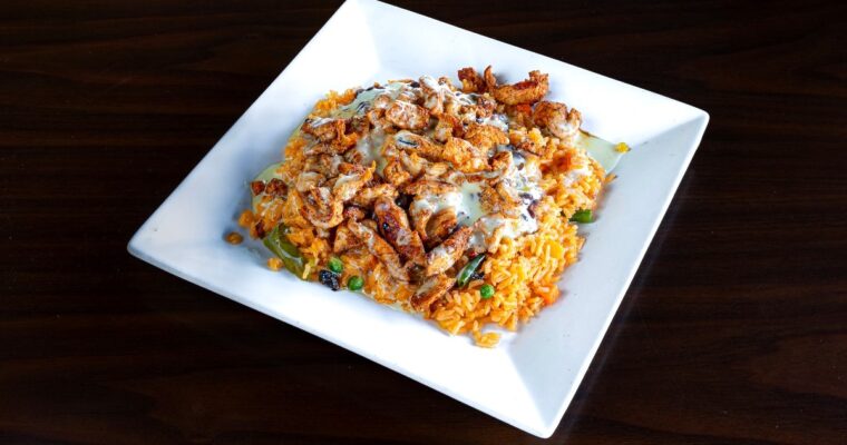 Discover the Irresistible Fusion of Flavors in Arroz con Pollo con MAMBO
