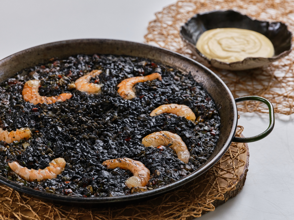 Indulge in the Rich Flavors of Arroz Negro con Chipirones at MAMBO